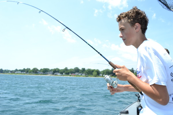 Connor Cinelli fishes in Lake Erie with his father, Chris.  Credit: Justin Sondel